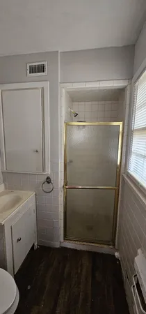 a bathroom with a sink toilet and shower