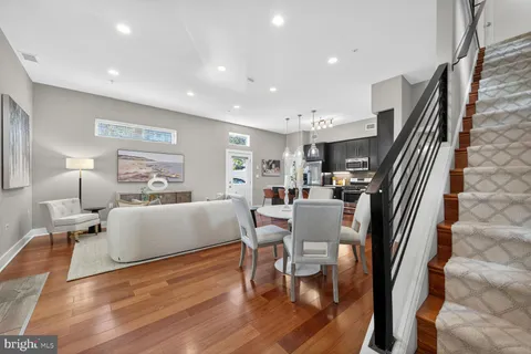 a living room with fireplace furniture and a wooden floor