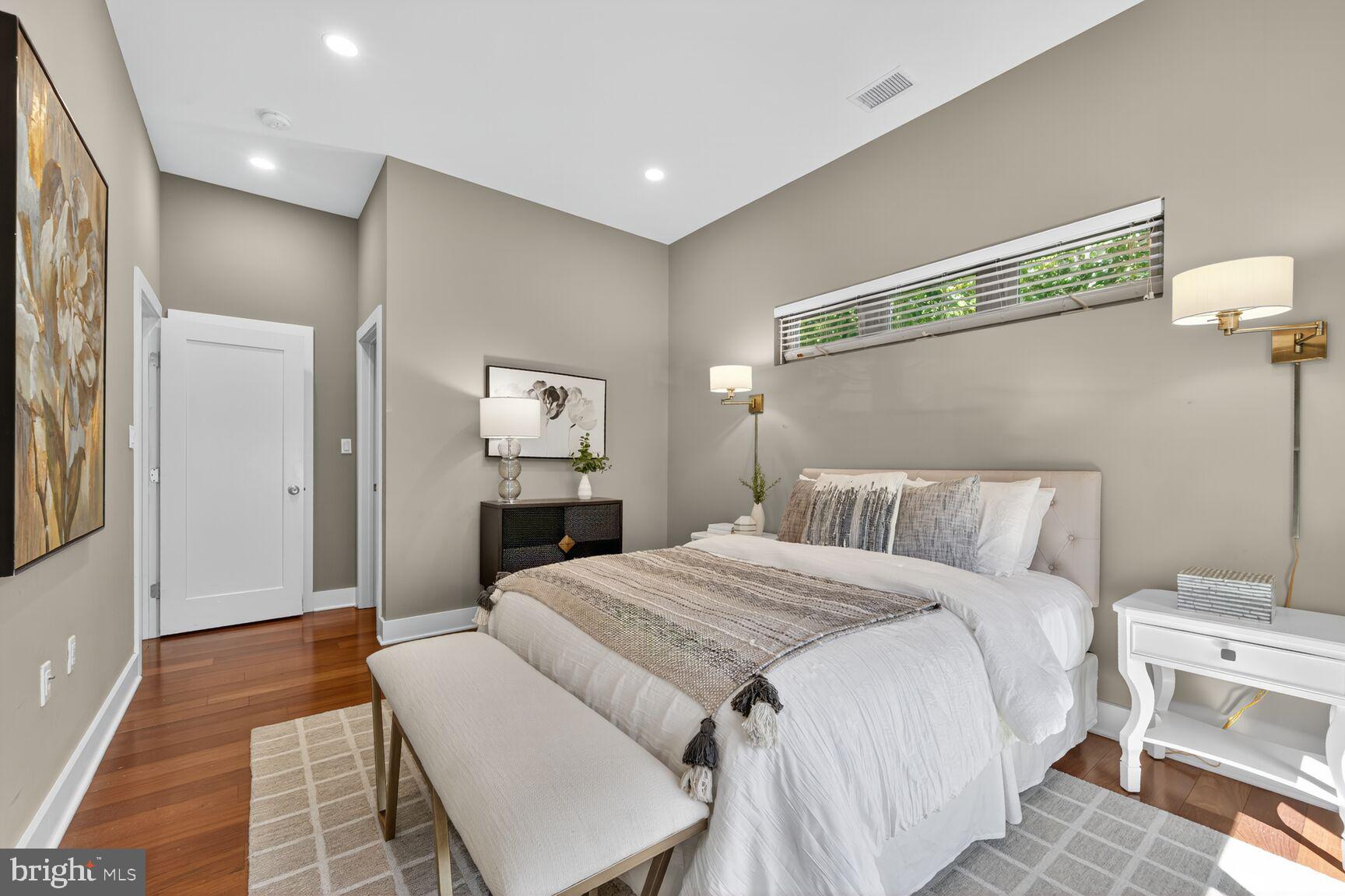 762 Park Road Northwest, Unit 7 Washington, DC 20010 - Photo 13 of 33 a bed room with a bed and a mirror