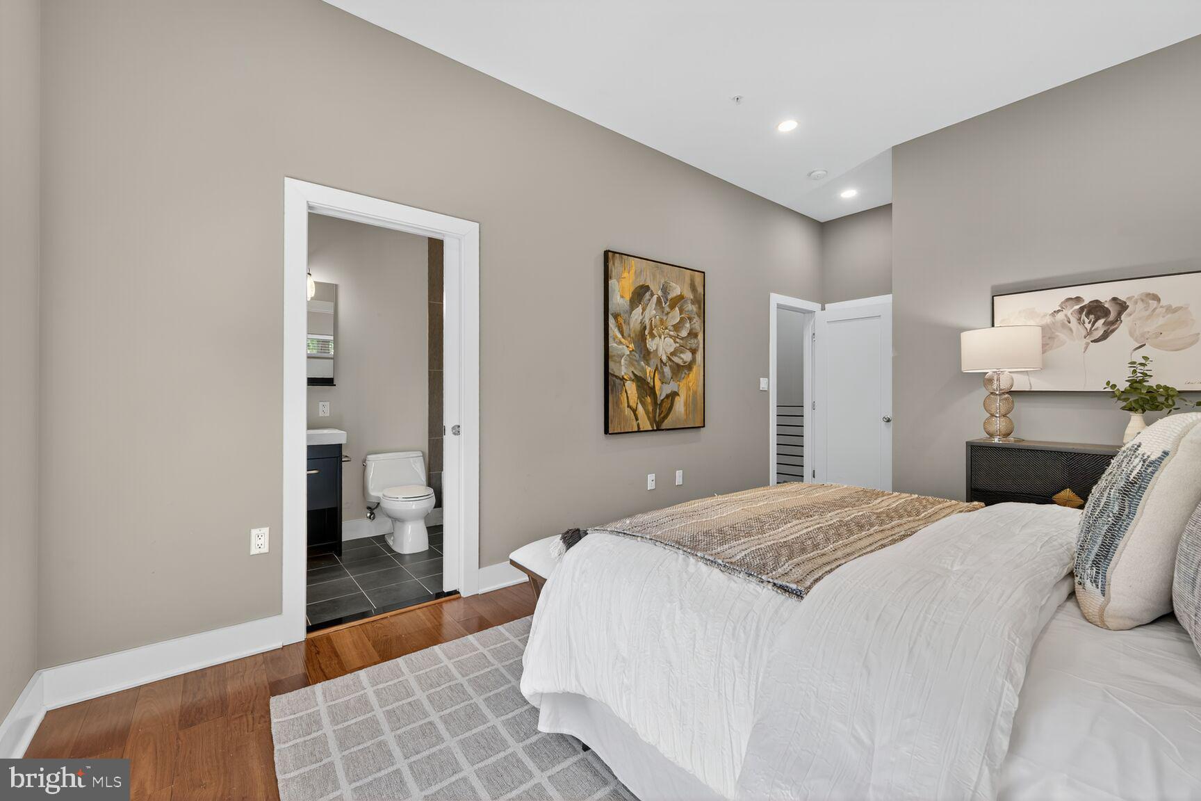 762 Park Road Northwest, Unit 7 Washington, DC 20010 - Photo 14 of 33 a bedroom with a bed and wooden floor