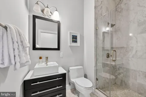 a bathroom with a toilet a sink and mirror