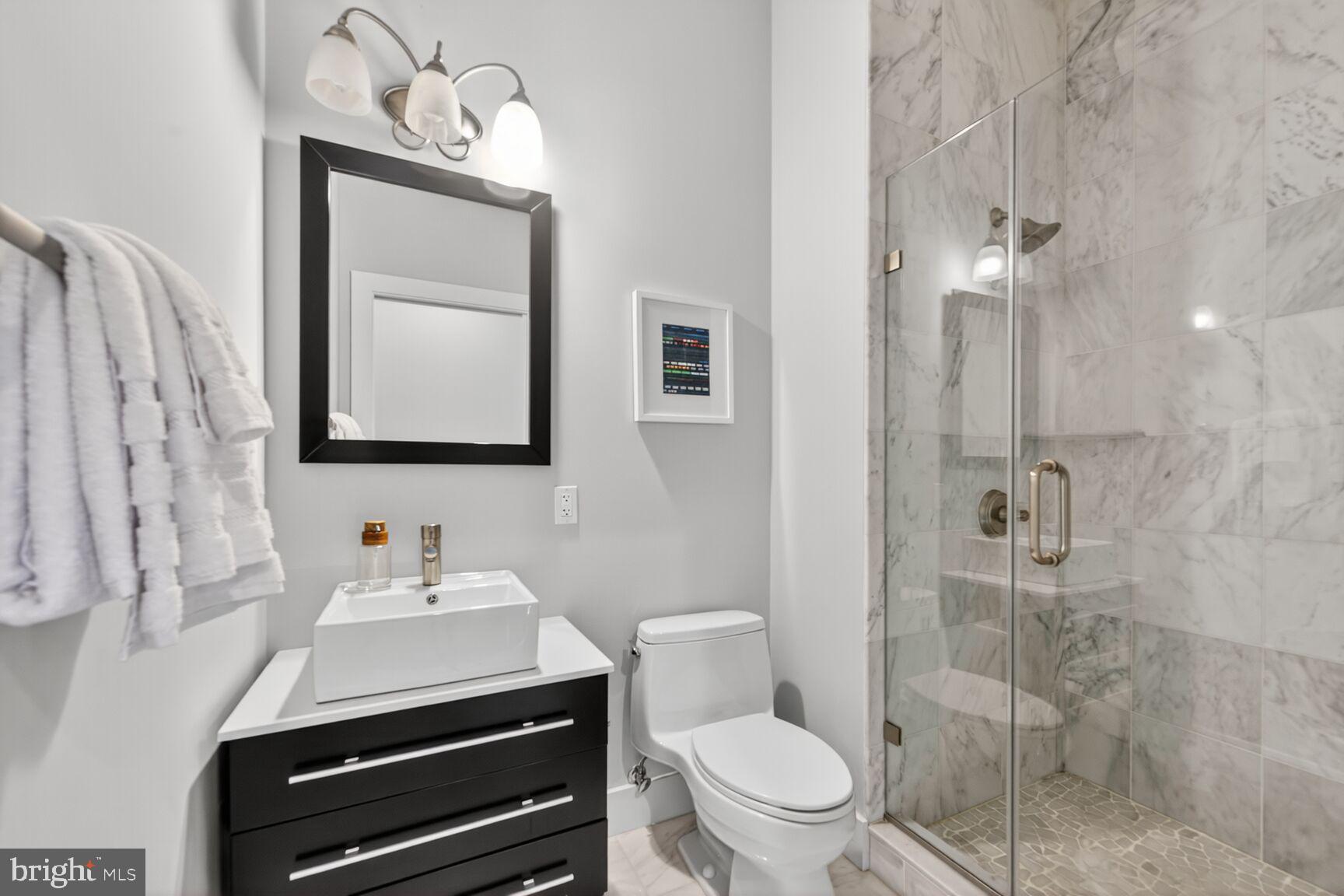 762 Park Road Northwest, Unit 7 Washington, DC 20010 - Photo 17 of 33 a bathroom with a toilet a sink and mirror