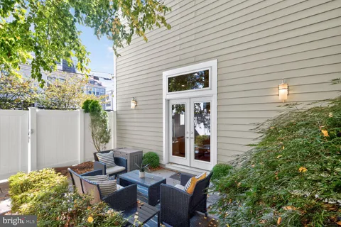 a view of backyard of house with seating space