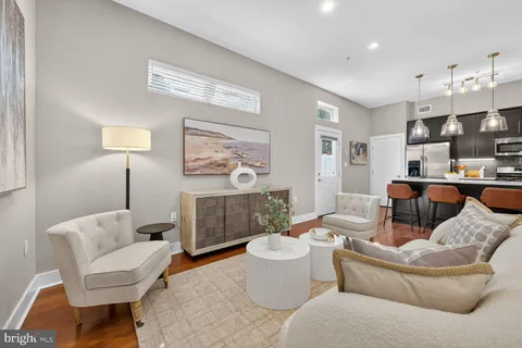 a living room with furniture a lamp and a window