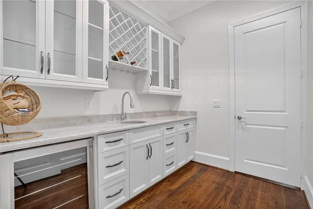 a kitchen with stainless steel appliances granite countertop a dining table chairs stove refrigerator and cabinets