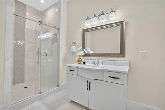 a spacious bathroom with a double vanity sink a large mirror and a bathtub