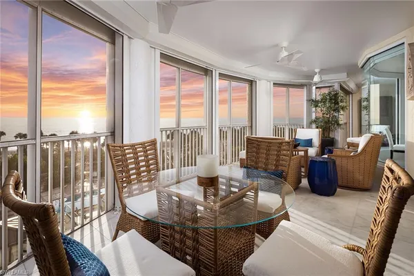 a living room with furniture and a floor to ceiling window