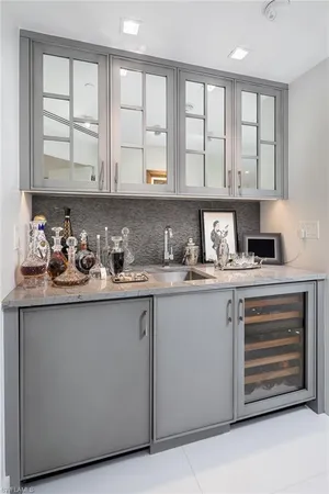 a kitchen with stainless steel appliances white cabinets and a window