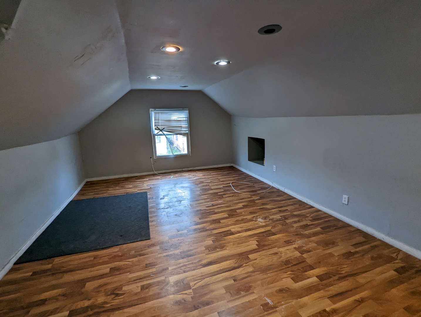 10515 South Perry Avenue Chicago, IL 60628 - Photo 2 of 10 an empty room with wooden floor and windows