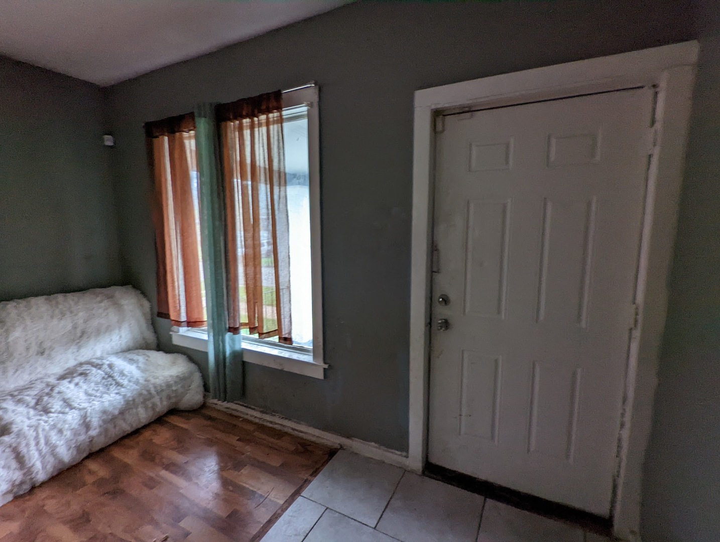 10515 South Perry Avenue Chicago, IL 60628 - Photo 5 of 10 a bedroom with a bed and a window