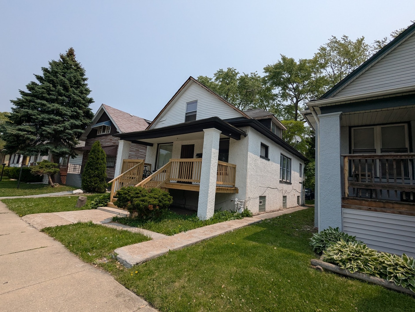 10515 South Perry Avenue Chicago, IL 60628 - Photo 7 of 10 front view of a house with a yard
