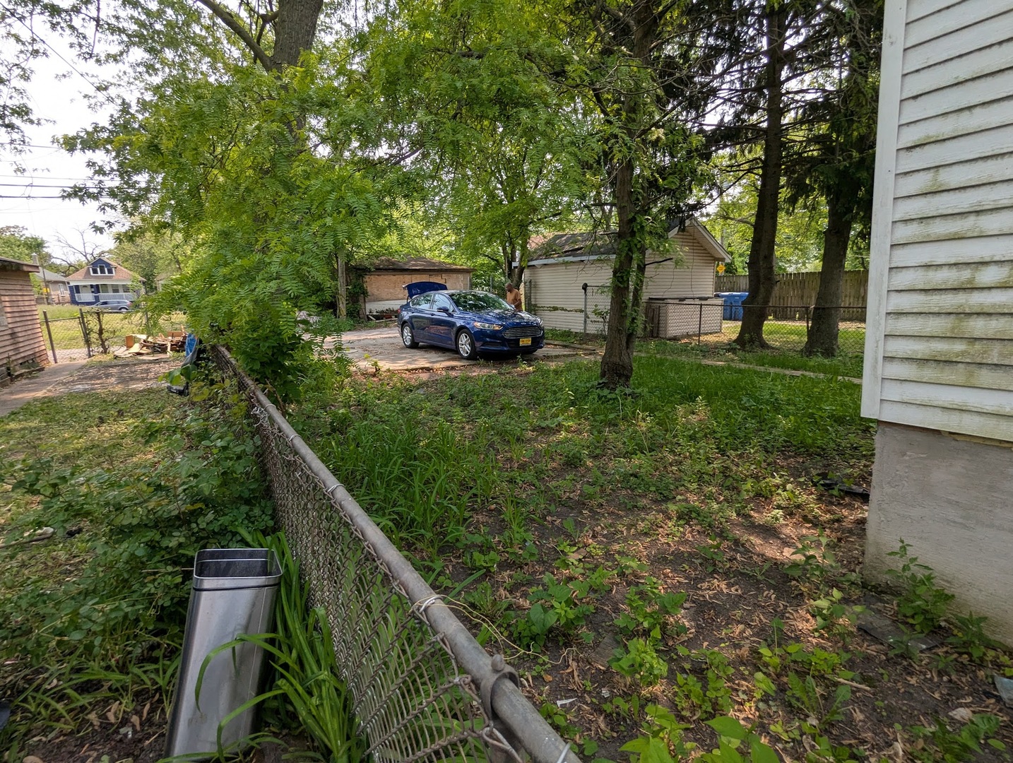 10515 South Perry Avenue Chicago, IL 60628 - Photo 10 of 10 a couple of cars parked in front of a house