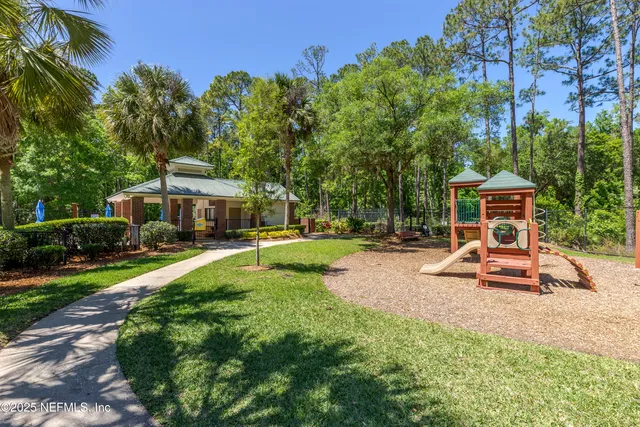 a view of a house with backyard porch and sitting area