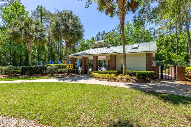 a view of a house with swimming pool and sitting area
