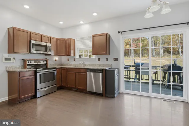 a kitchen with stainless steel appliances a stove a sink and a refrigerator