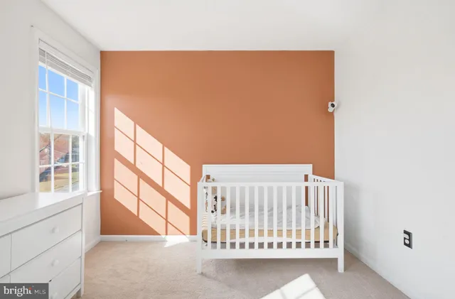a view of a bedroom with furniture and windows