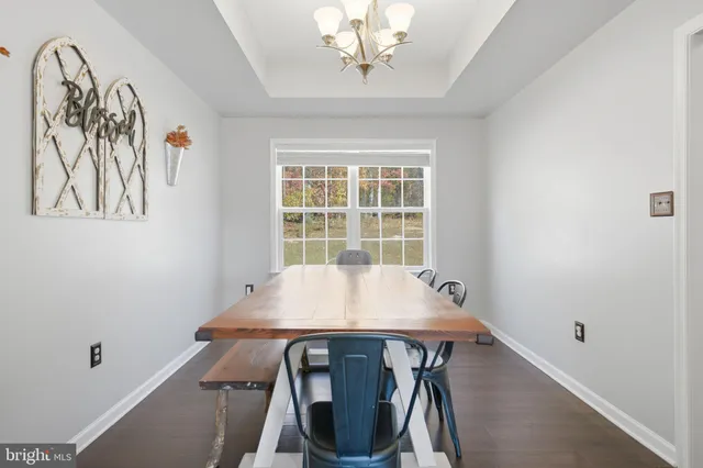 a view of a dining room with furniture and window