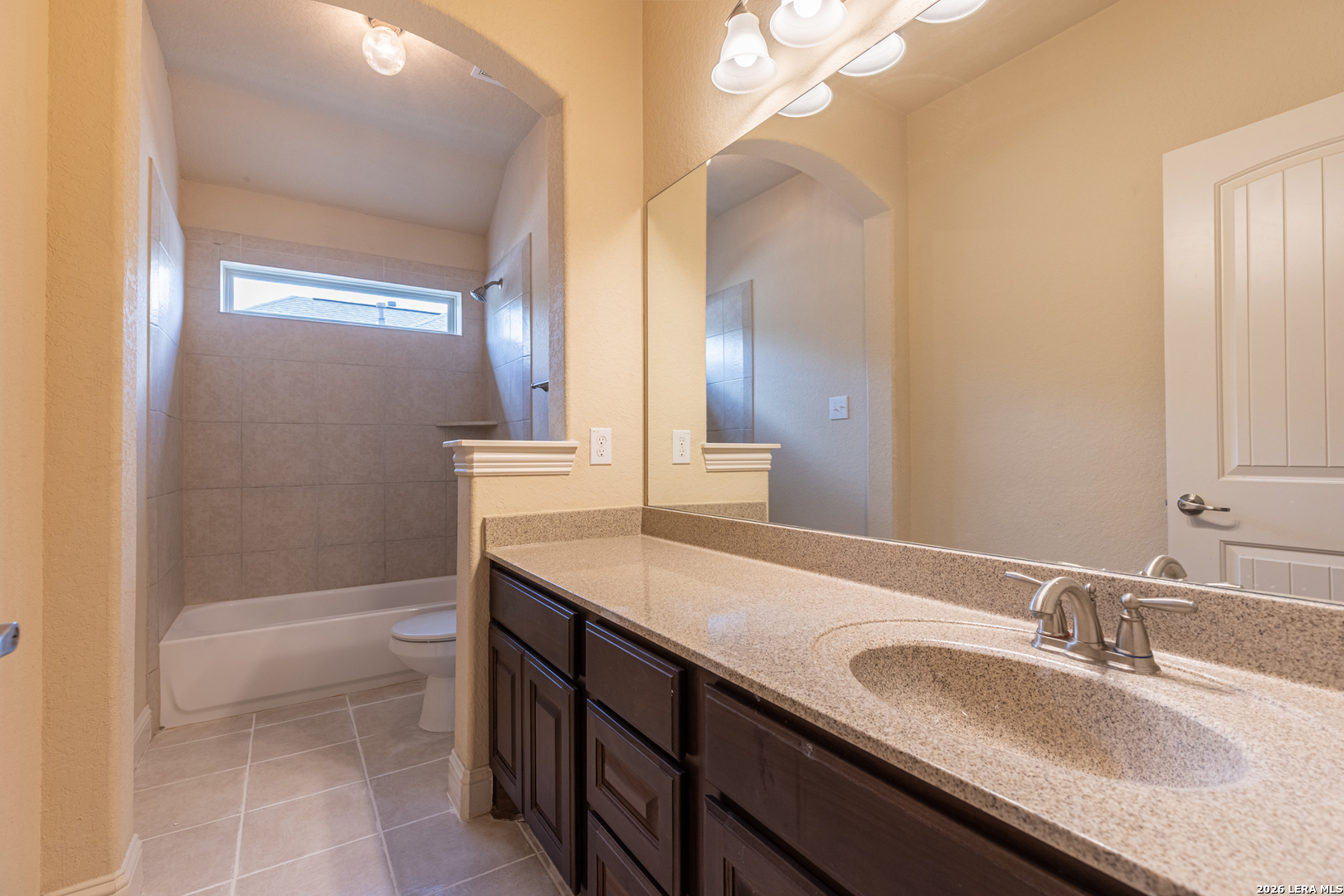 8103 Mystic Chase Boerne, TX 78015 - Photo 33 of 49 a bathroom with a granite countertop sink a toilet a mirror and bathtub
