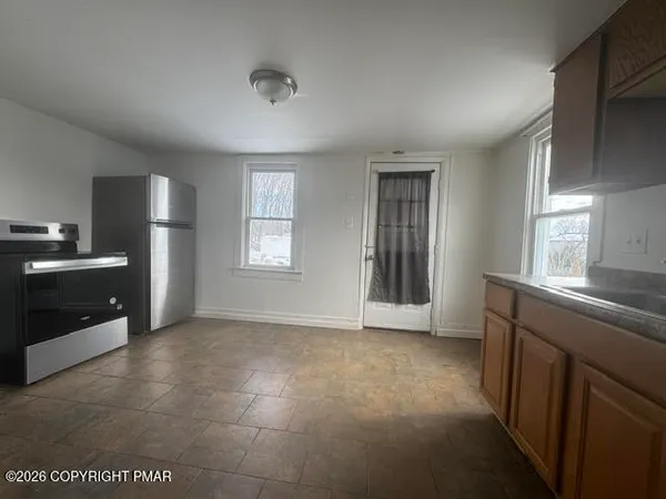a view of a kitchen with a sink and dishwasher kitchen appliances