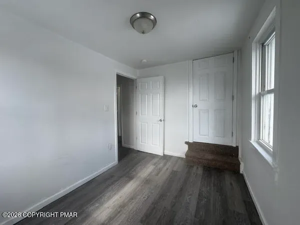 a view of room with window and hardwood floor