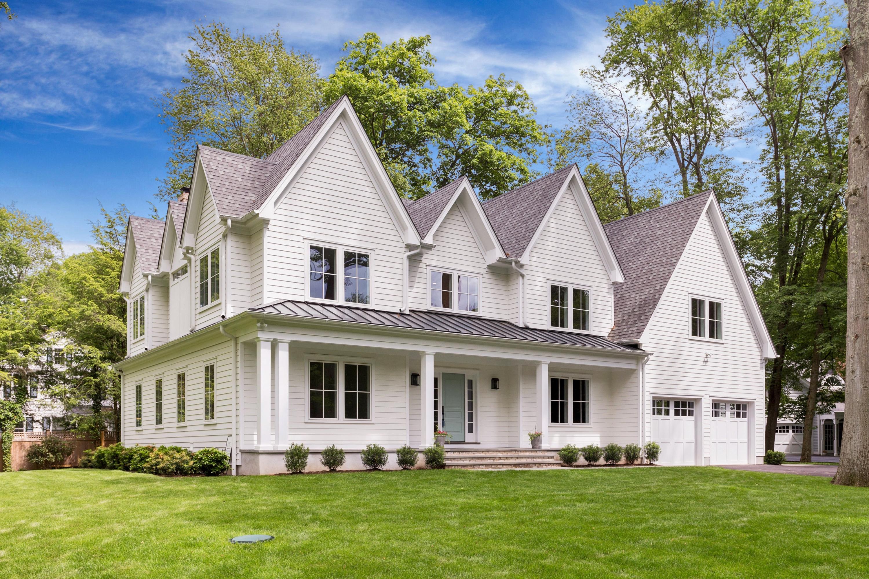 a front view of a house with a yard and porch