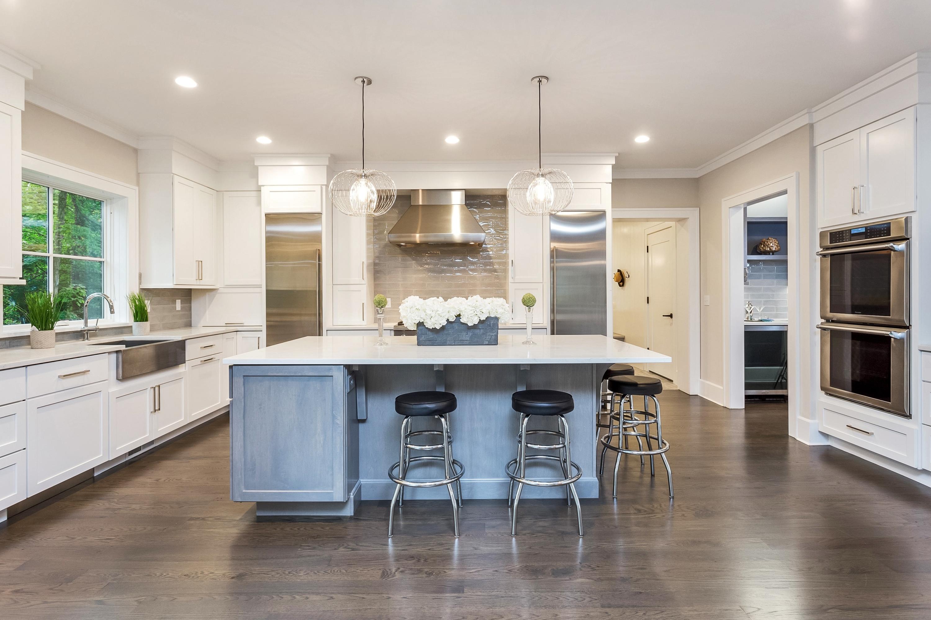 11 Rocaton Road Darien, CT 06820 - Photo 13 of 38 a kitchen with stainless steel appliances kitchen island granite countertop a table chairs sink and cabinets