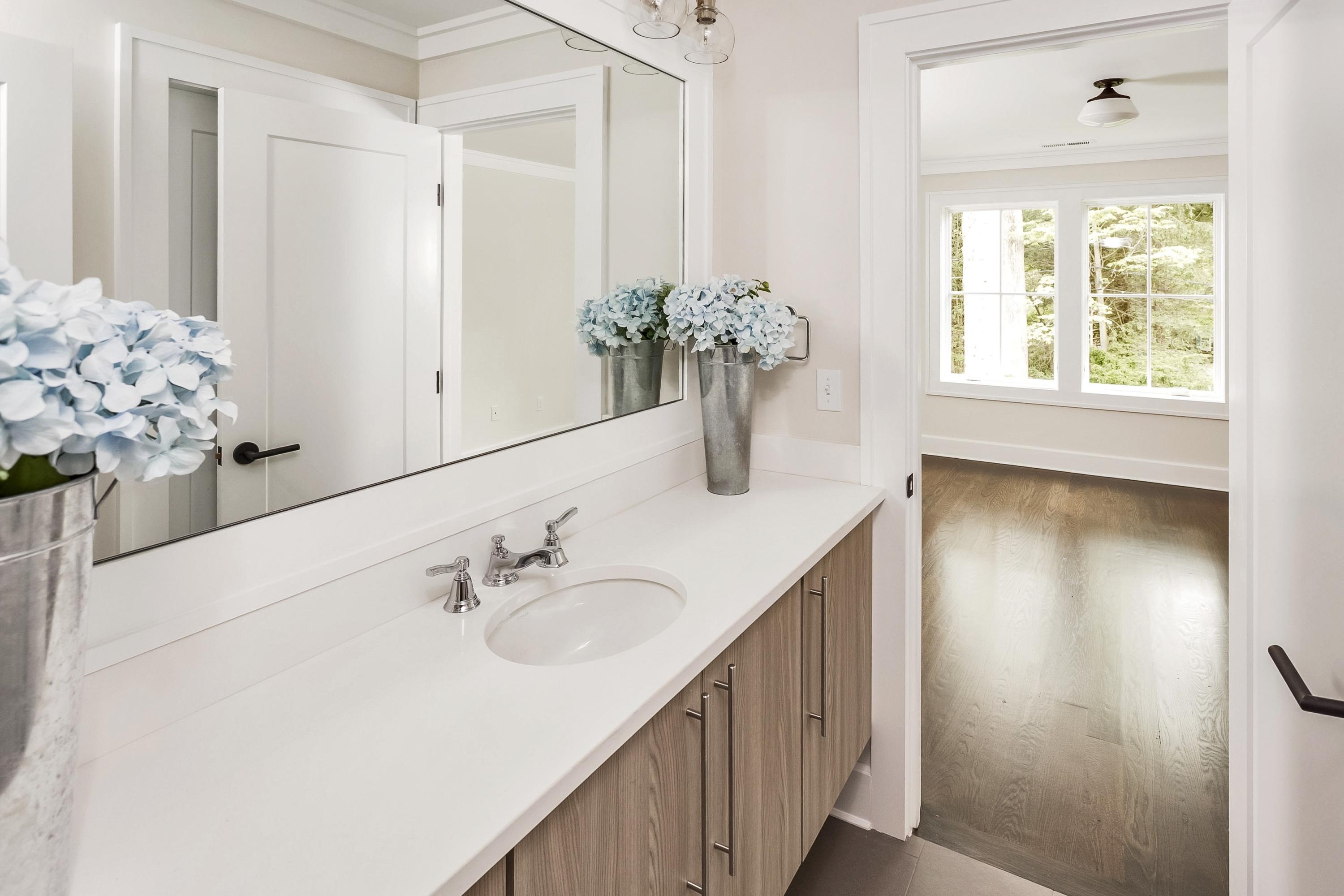 11 Rocaton Road Darien, CT 06820 - Photo 23 of 38 a bathroom with a sink and mirror