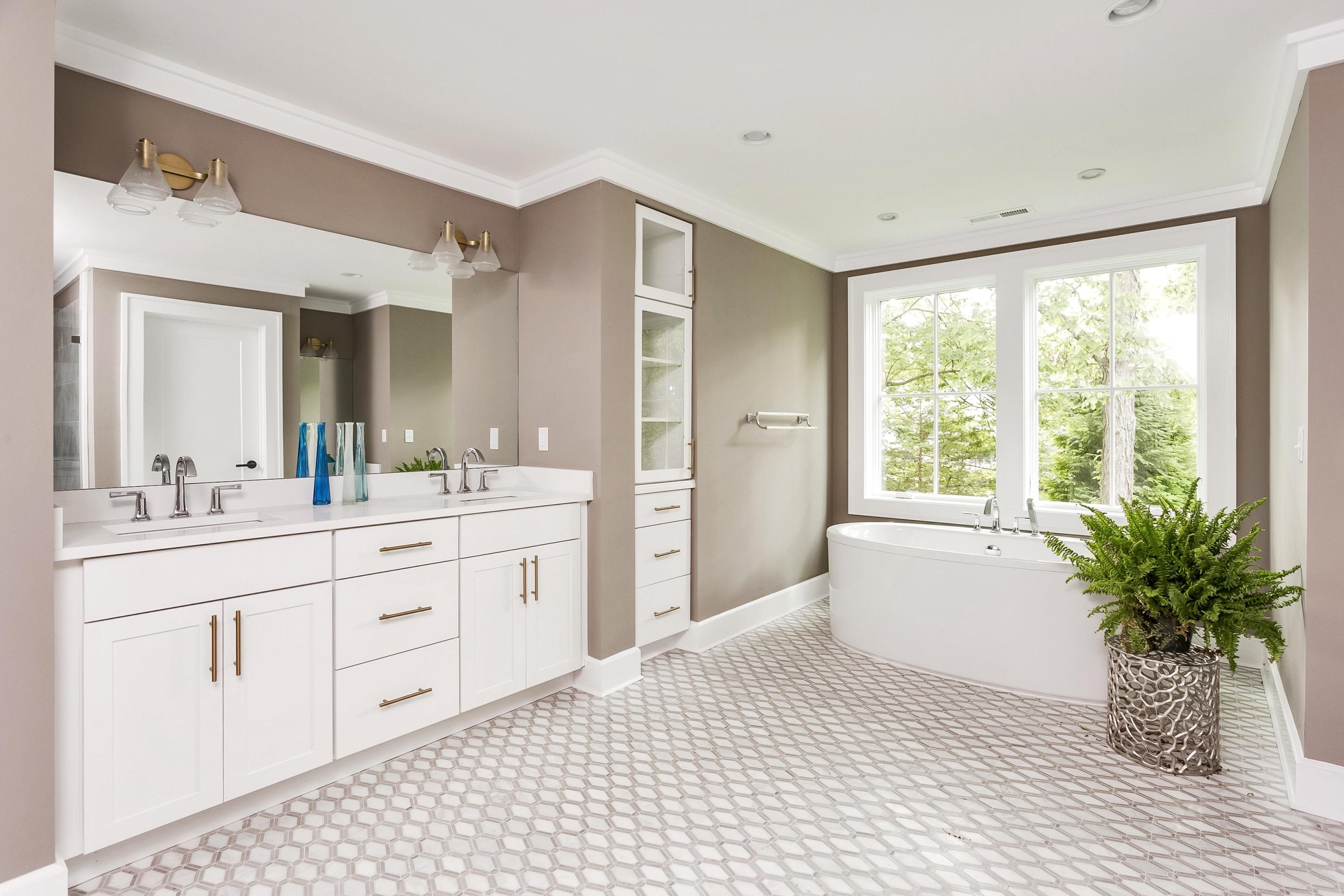 11 Rocaton Road Darien, CT 06820 - Photo 29 of 38 a bathroom with a sink a large mirror a bathtub and a shower