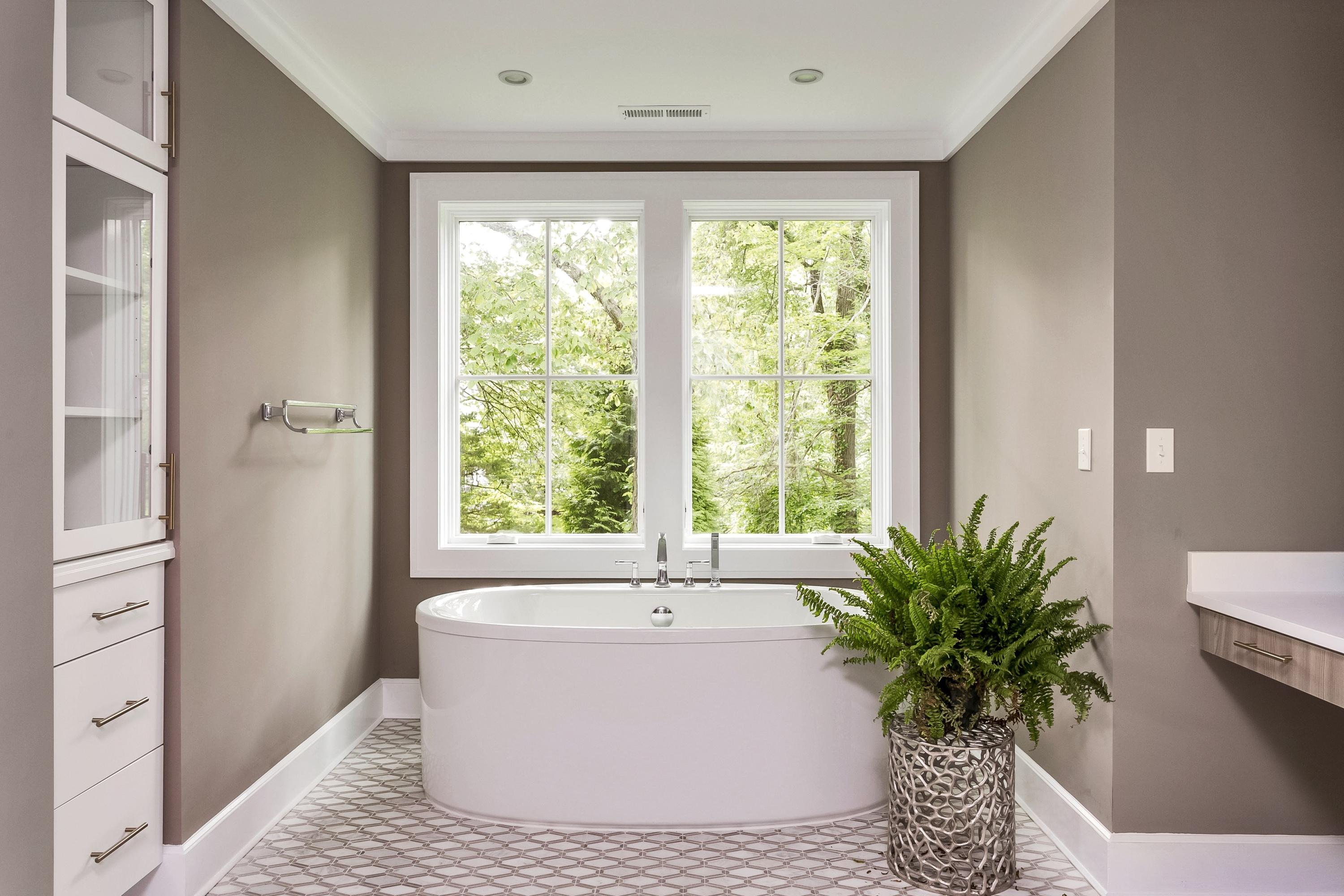 11 Rocaton Road Darien, CT 06820 - Photo 30 of 38 a white bath tub sitting in a bathroom next to a window