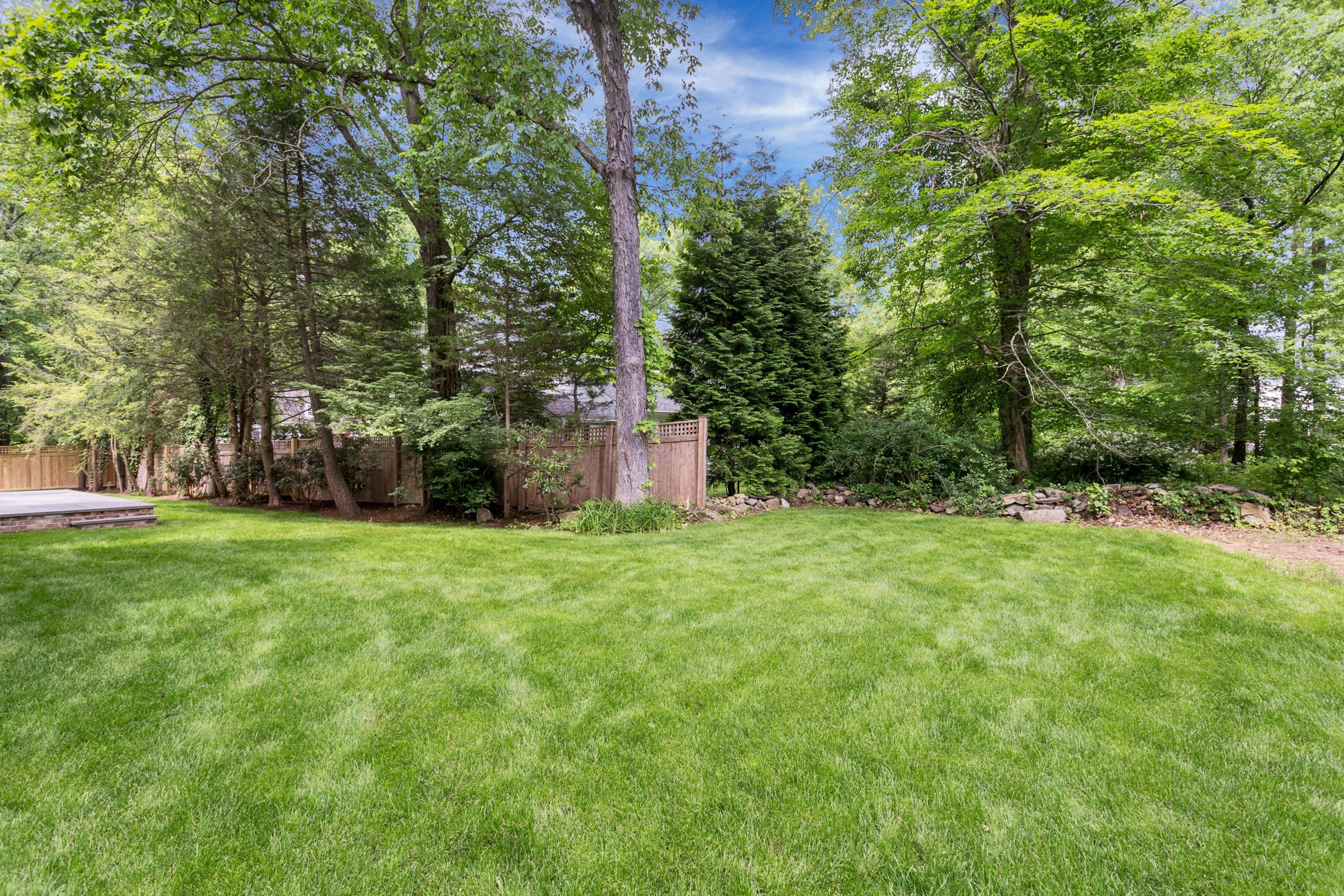 11 Rocaton Road Darien, CT 06820 - Photo 33 of 38 a backyard of a house with lots of green space