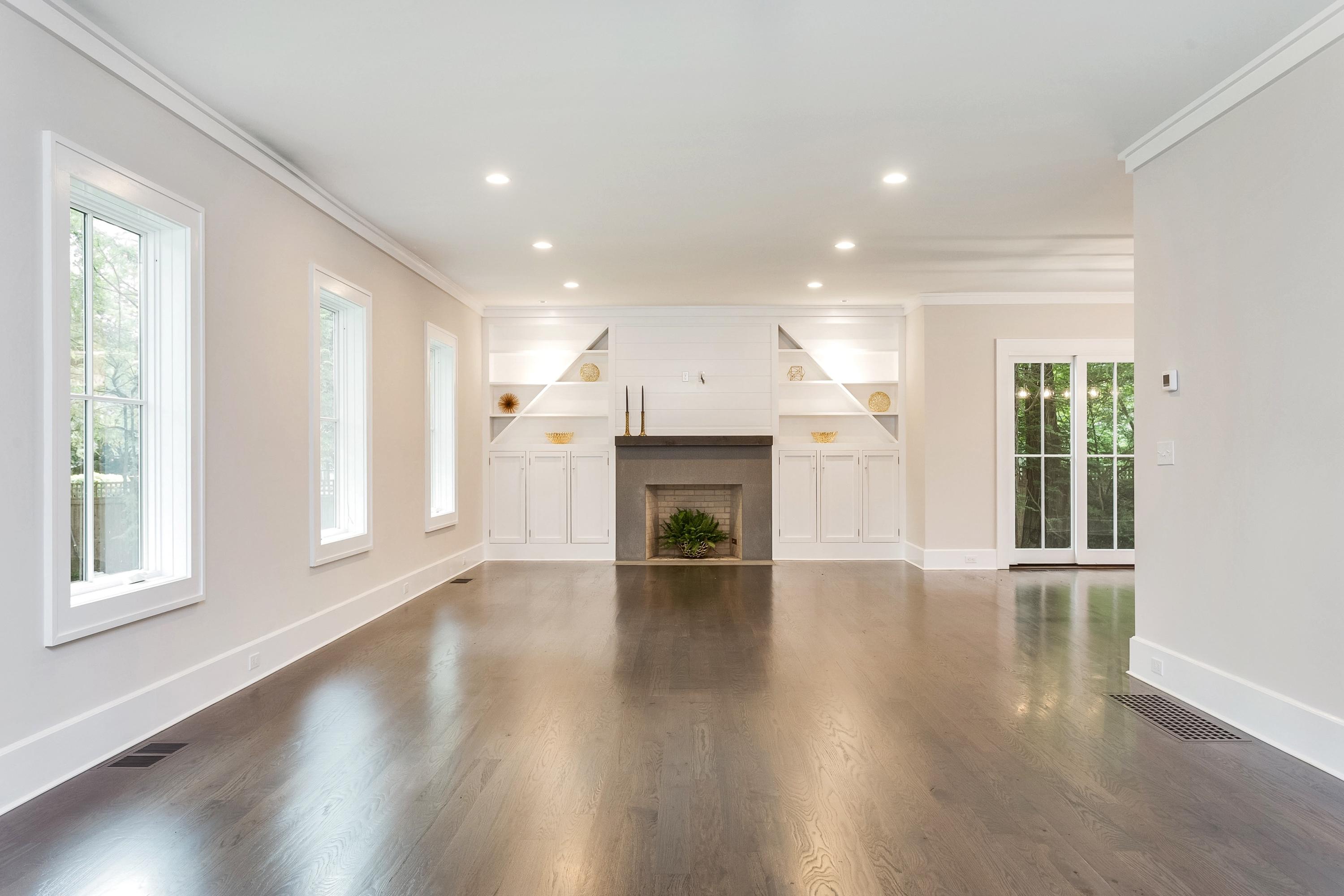 11 Rocaton Road Darien, CT 06820 - Photo 5 of 38 an empty room with wooden floor and a fireplace
