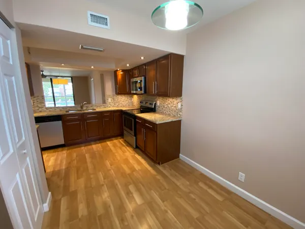 a kitchen with stainless steel appliances granite countertop a sink and a stove