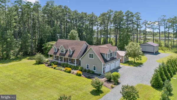 an aerial view of a house with swimming pool and garden