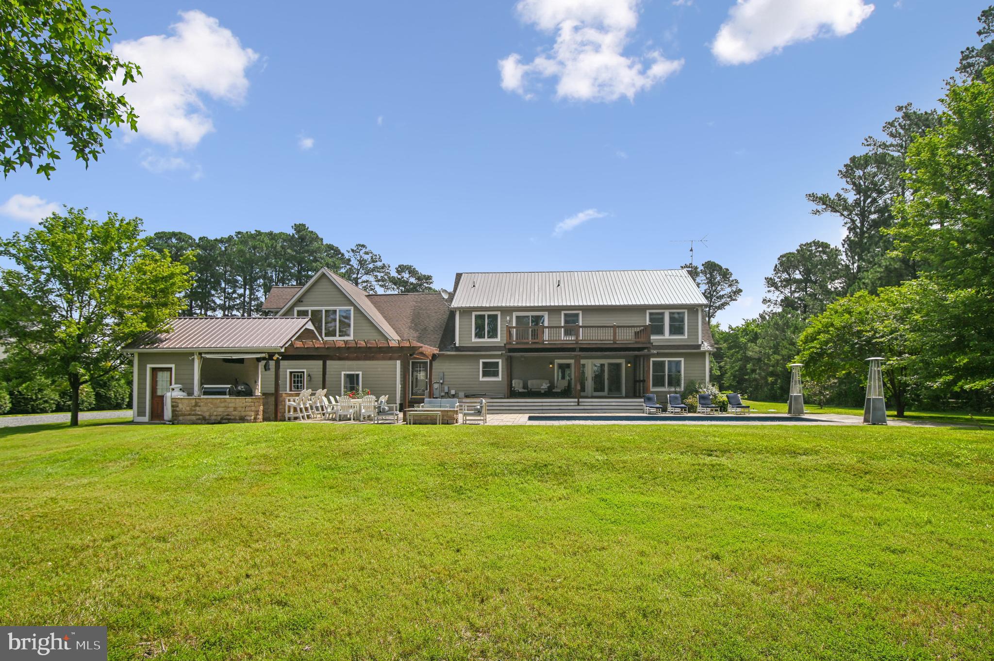 6670 Tilghman Island Road Sherwood, MD 21665 - Photo 12 of 64 a view of a house with a big yard and palm trees