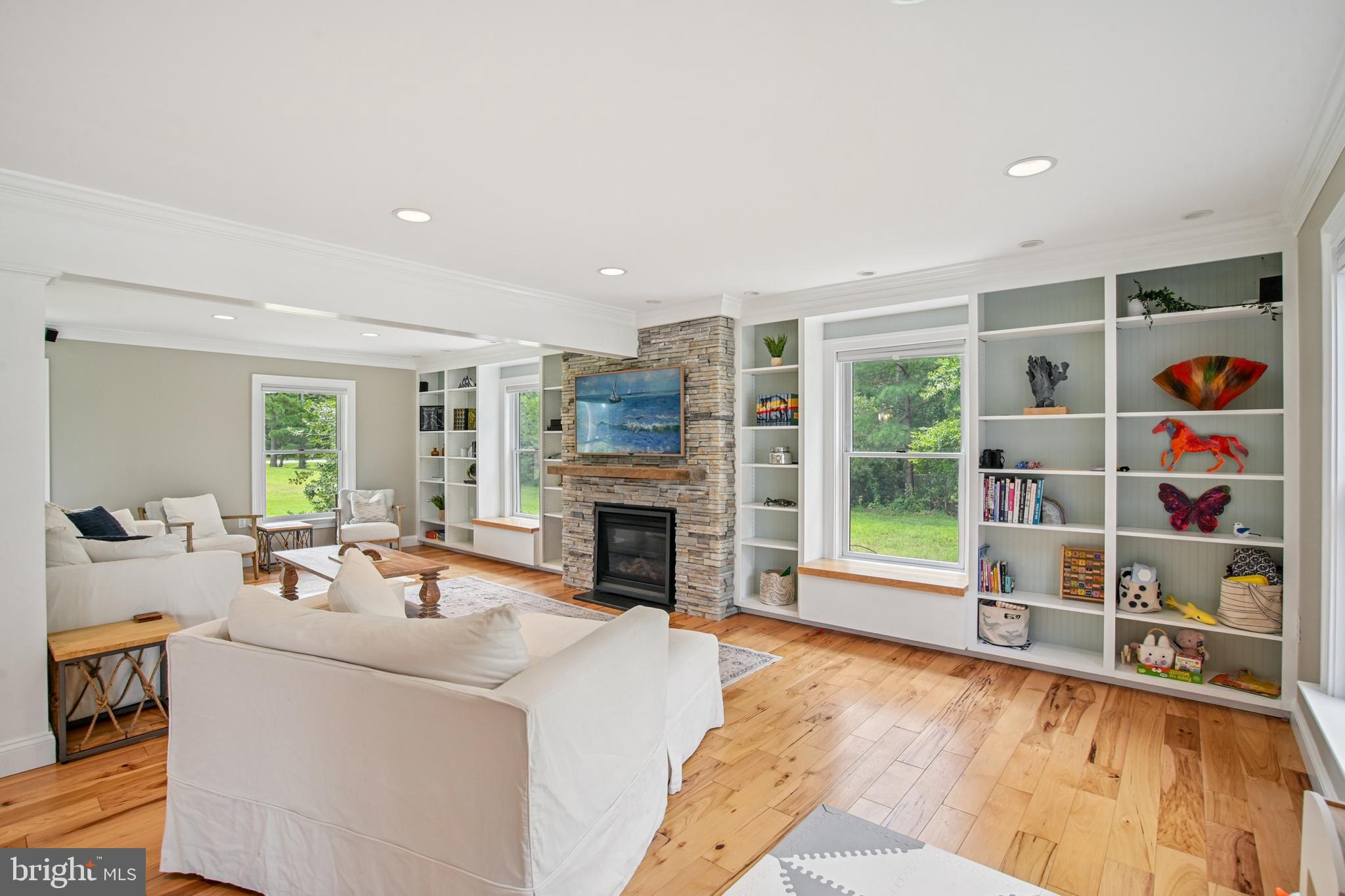 6670 Tilghman Island Road Sherwood, MD 21665 - Photo 37 of 64 a living room with fireplace furniture and a floor to ceiling window