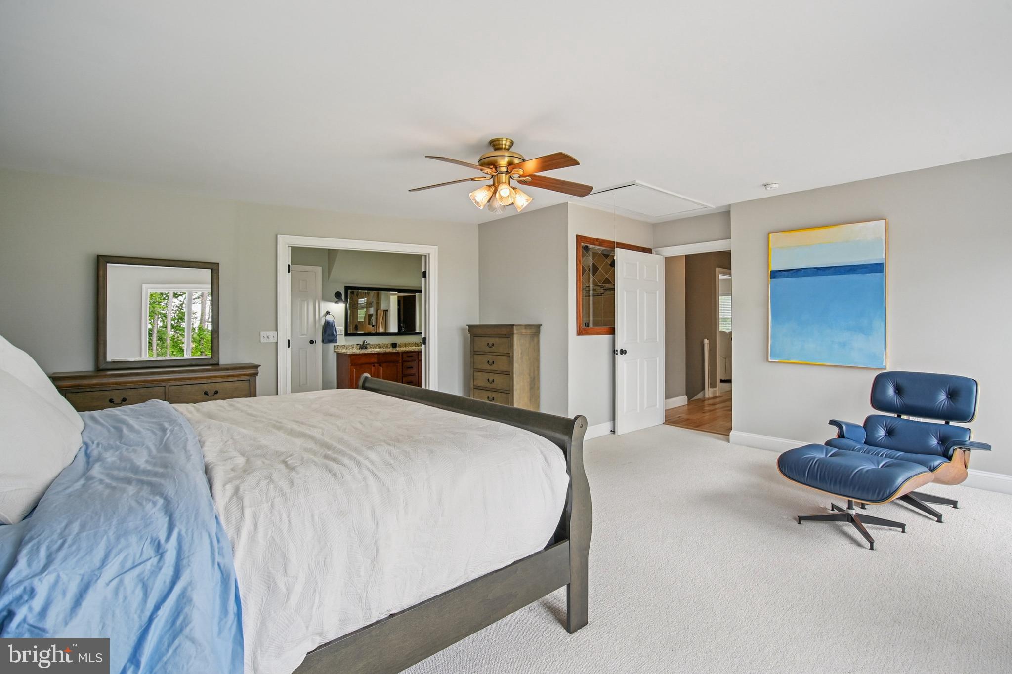 6670 Tilghman Island Road Sherwood, MD 21665 - Photo 45 of 64 a bedroom with a bed and a chandelier