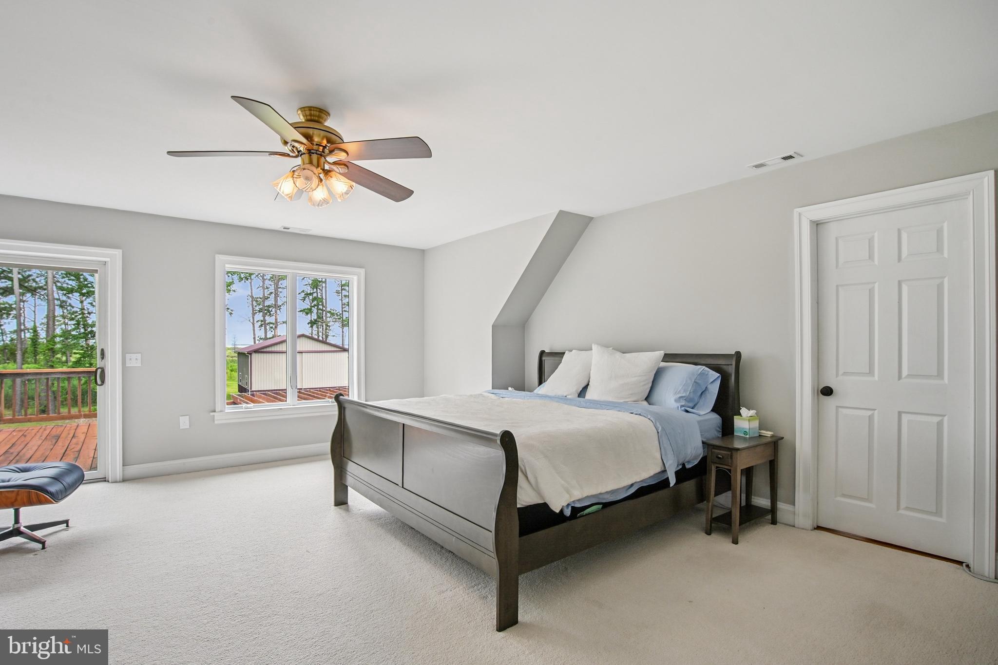 6670 Tilghman Island Road Sherwood, MD 21665 - Photo 47 of 64 a spacious bedroom with a bed and a window