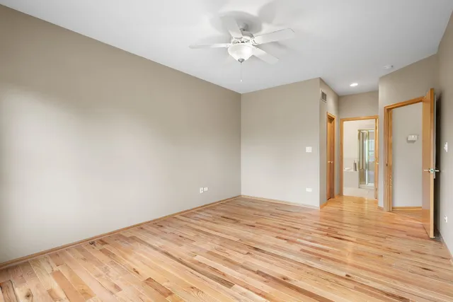 a view of an empty room and wooden floor