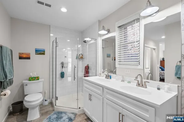 a bathroom with a sink a toilet and shower