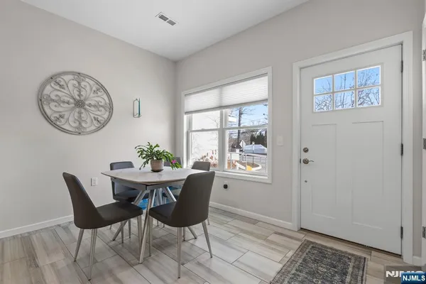 a view of a dining room with furniture and window