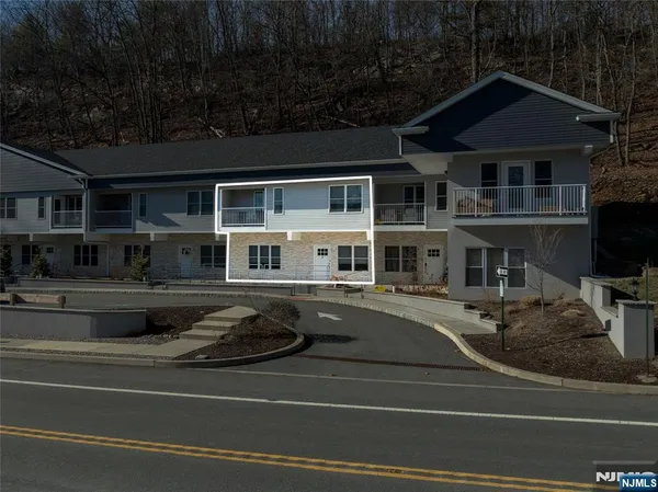 a view of a house and a pool table and chairs with wooden fence