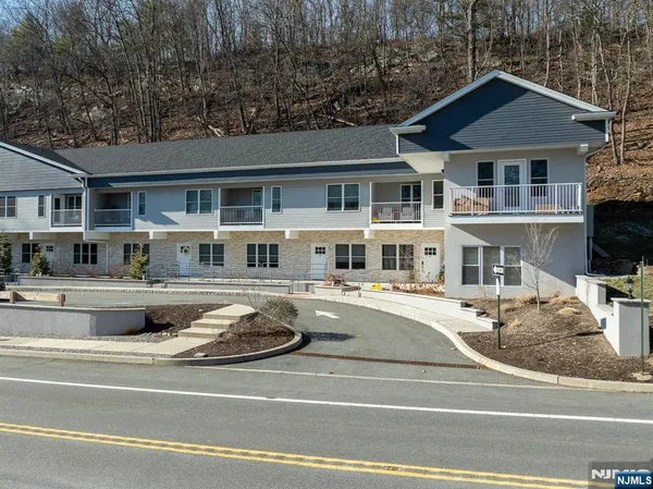 a front view of residential houses with yard