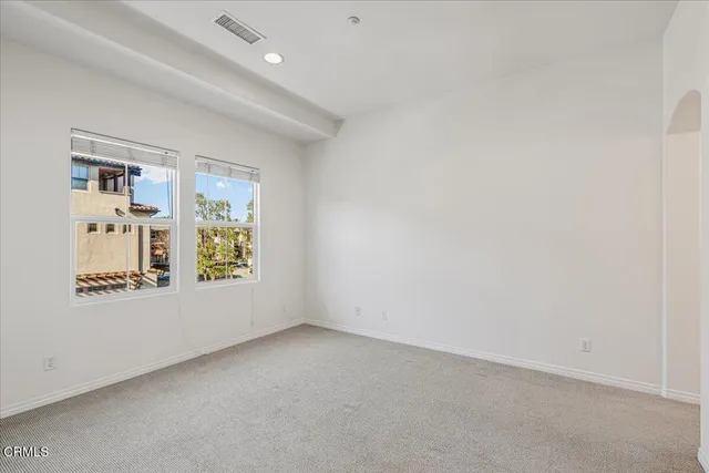 a view of a room with a sink and mirror