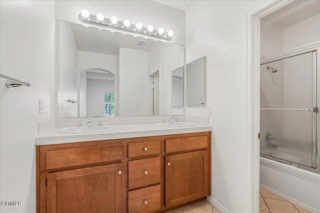 a bathroom with a glass shower door