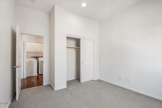 an empty room with closet area