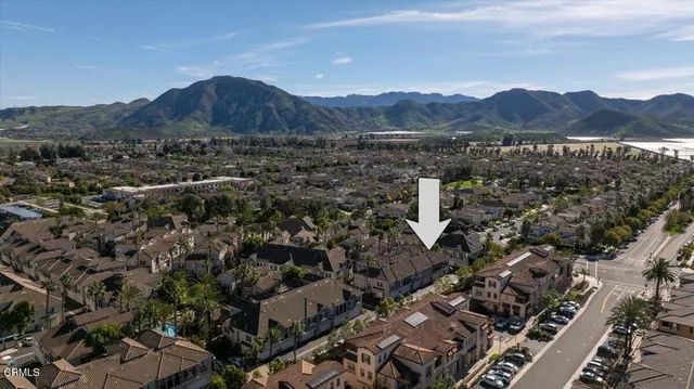 an aerial view of residential house with sandy dunes and trees