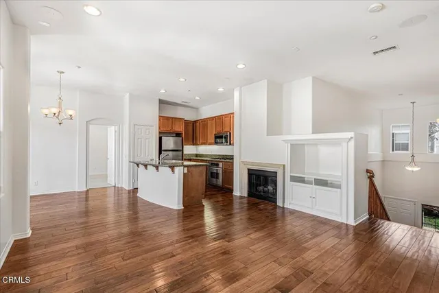 a view of kitchen with wooden floor and electronic appliances
