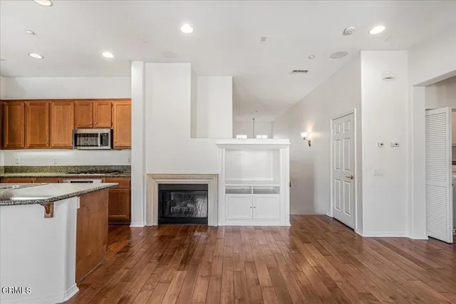 a kitchen with a refrigerator and a stove top oven