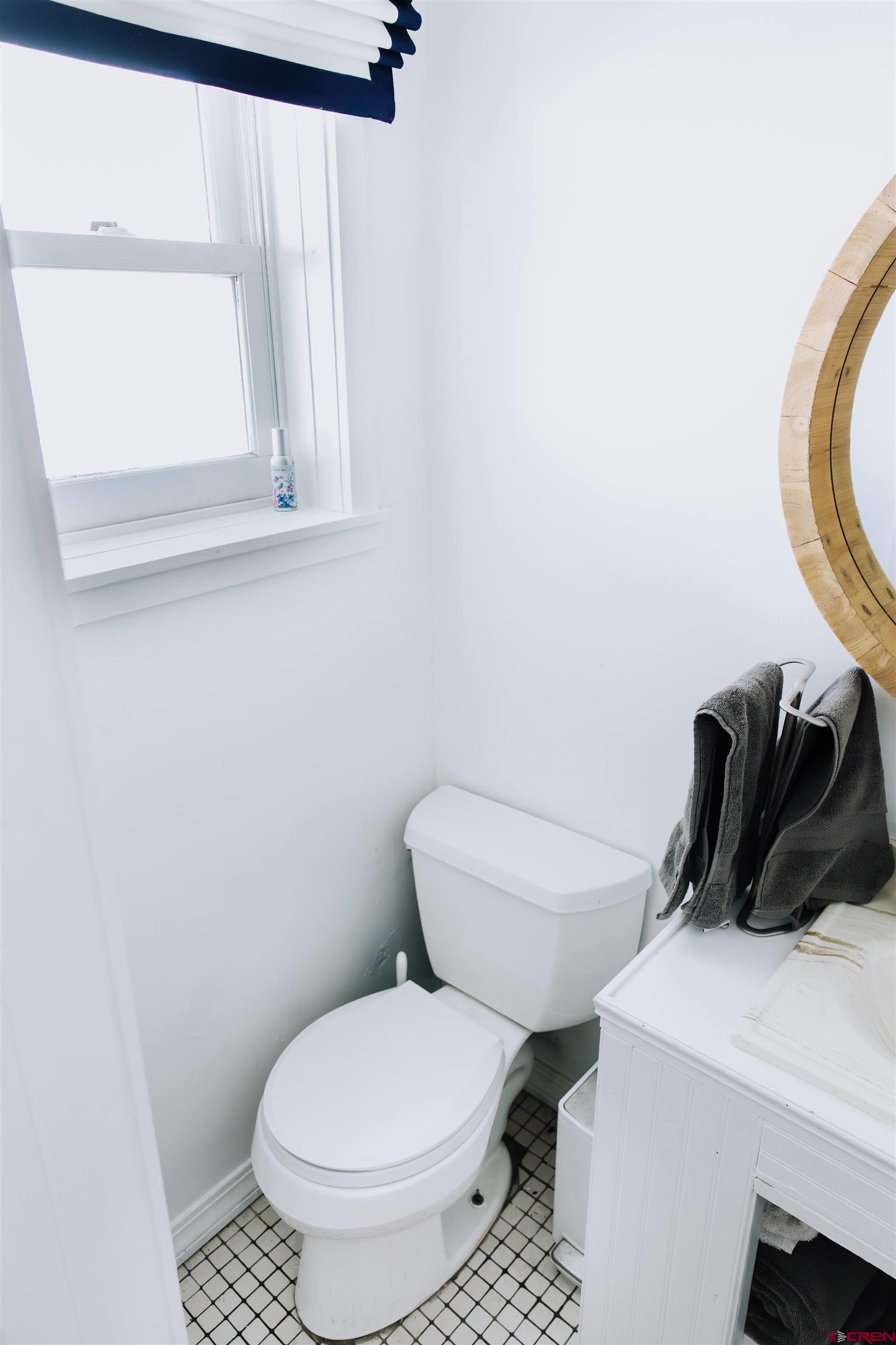 218 Maroon Avenue, Unit E Crested Butte, CO 81224 - Photo 14 of 22 a white toilet sitting next to a bathroom sink