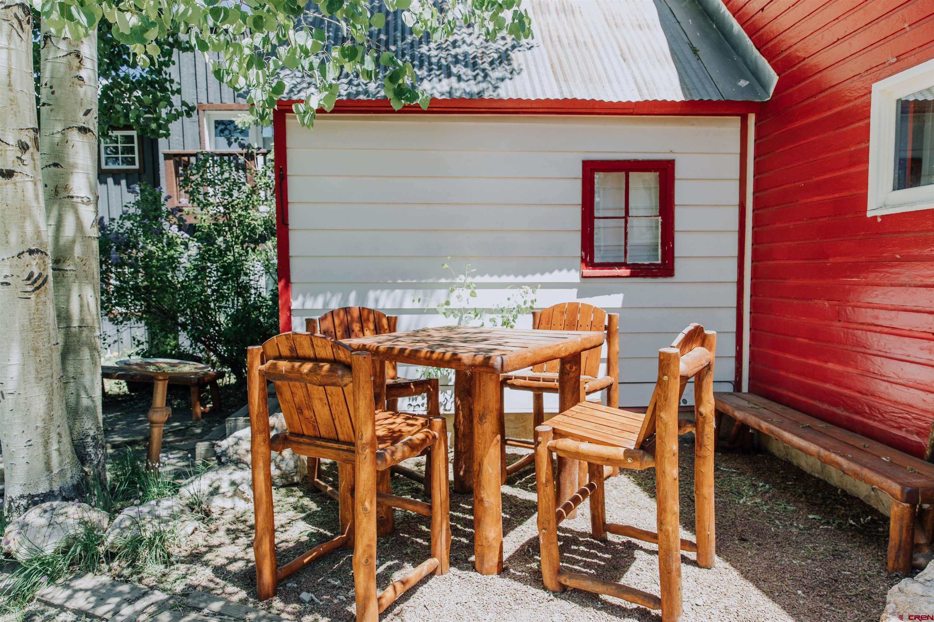 218 Maroon Avenue, Unit E Crested Butte, CO 81224 - Photo 17 of 22 a backyard of a house with table and chairs
